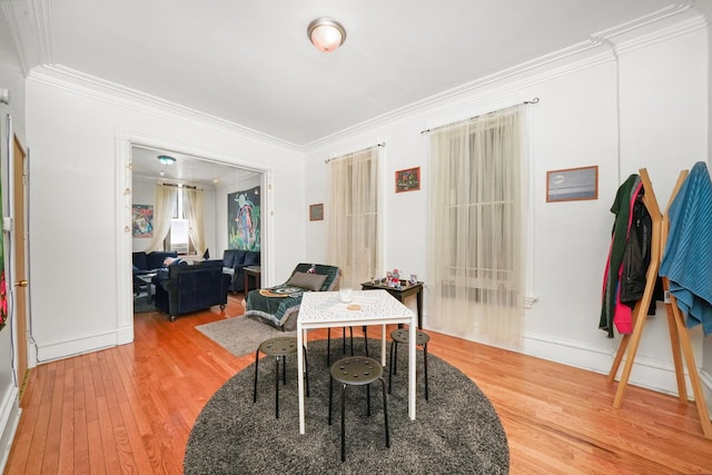 dining room with ornamental molding and wood-type flooring