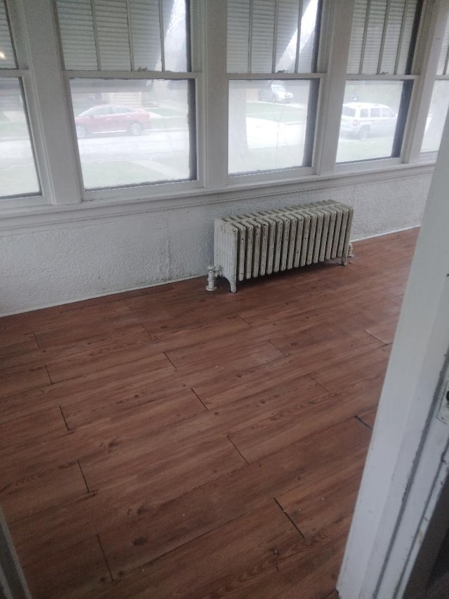 unfurnished sunroom with radiator