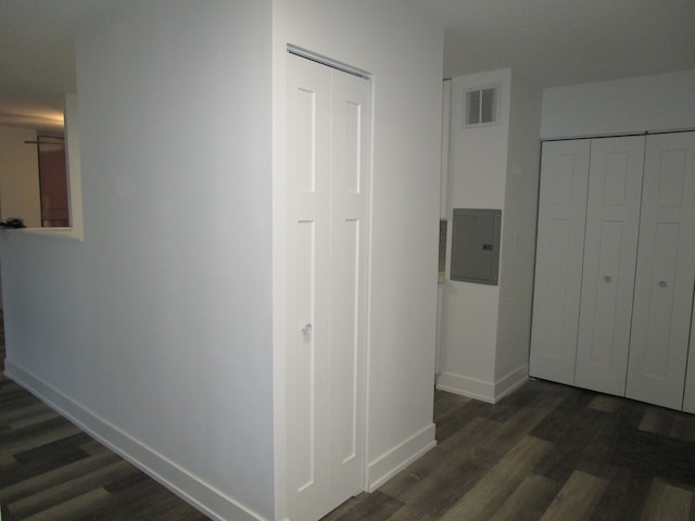 hallway with electric panel and dark hardwood / wood-style flooring