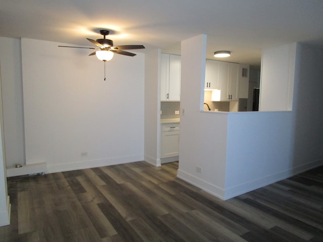 unfurnished living room featuring ceiling fan and dark hardwood / wood-style floors