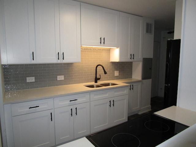 6730 S S Shore Dr Unit 1001, Chicago, IL 60649 - kitchen with white cabinetry, tasteful backsplash, a sink, and light countertops