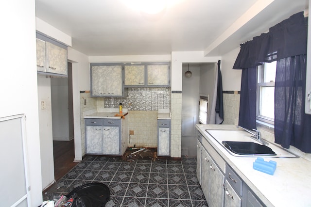 kitchen with gray cabinets, backsplash, dark hardwood / wood-style floors, and sink