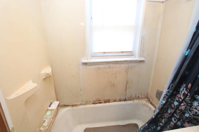 bathroom with a tub and a shower with curtain