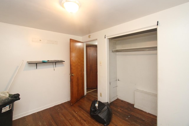 unfurnished bedroom featuring a closet and wood finished floors