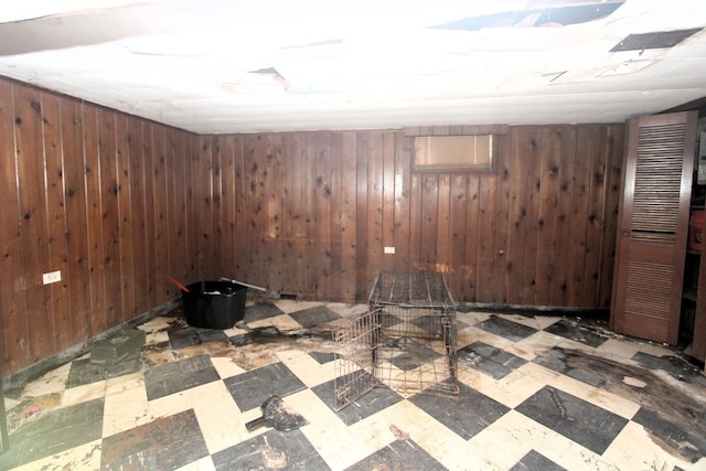 interior space featuring wooden walls and tile patterned floors