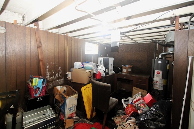 interior space featuring wood walls, visible vents, and gas water heater