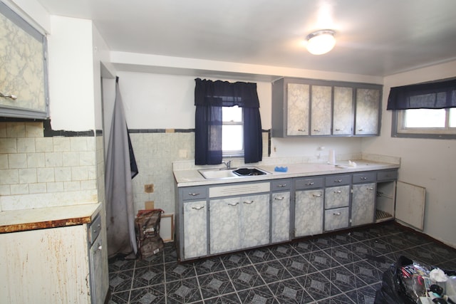 kitchen featuring a wealth of natural light, sink, and gray cabinets