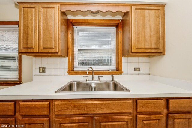 kitchen featuring backsplash and sink