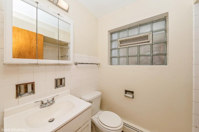 bathroom featuring vanity, toilet, tile walls, and decorative backsplash