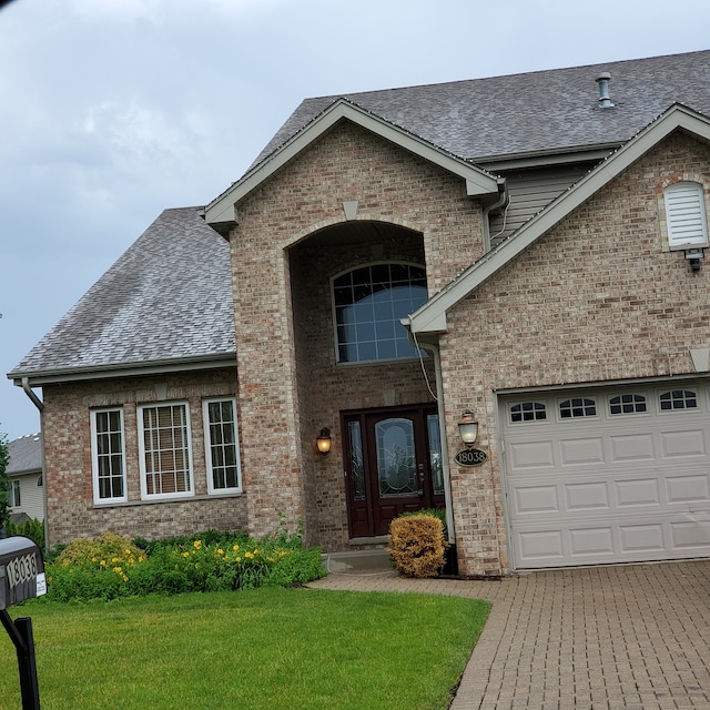 view of front of house featuring a front yard and a garage