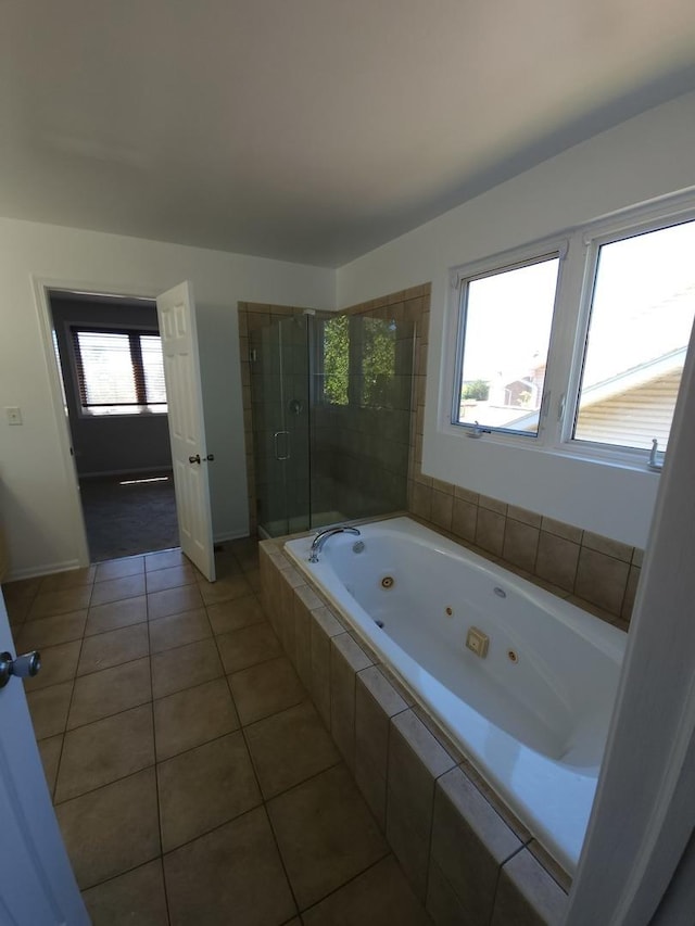 bathroom with a stall shower, plenty of natural light, tile patterned flooring, and a jetted tub