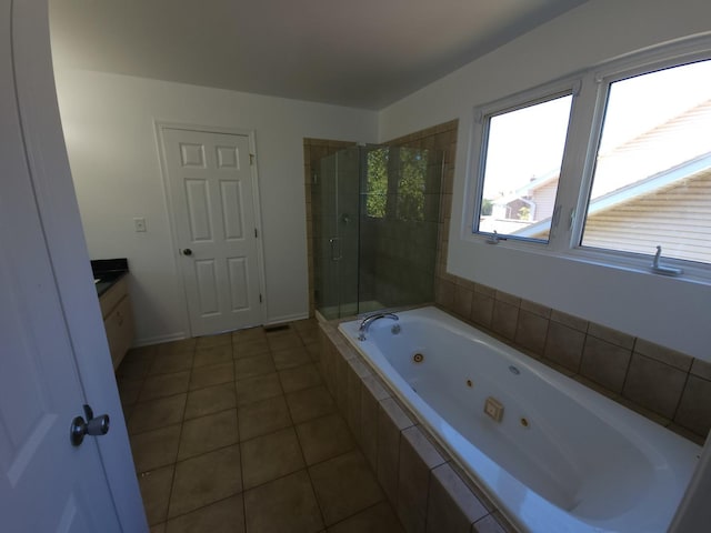 bathroom featuring tile patterned flooring, vanity, and shower with separate bathtub