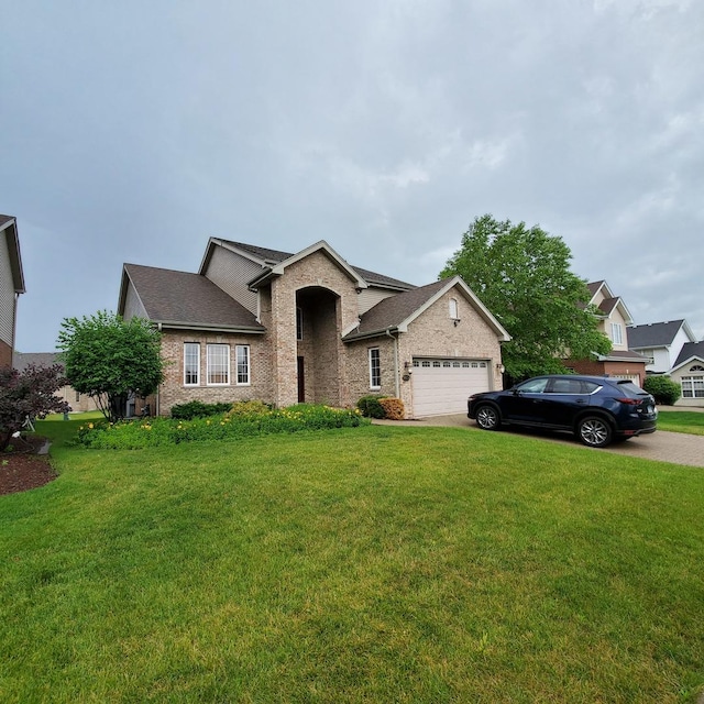 view of front of home with a front yard and a garage