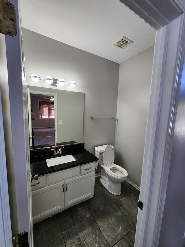 bathroom featuring vanity and toilet