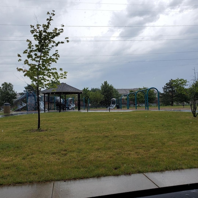 view of community with playground community, a lawn, and a gazebo