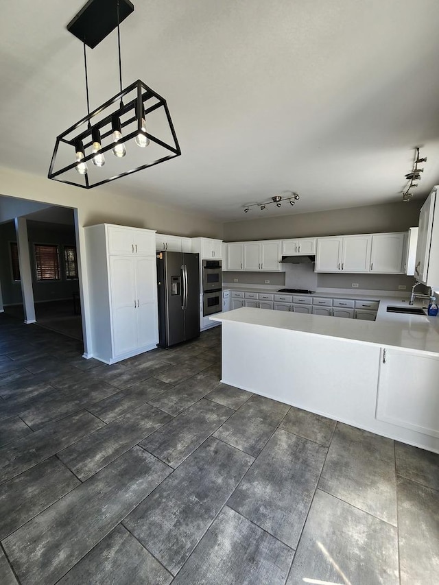 kitchen featuring decorative light fixtures, sink, white cabinetry, and stainless steel appliances