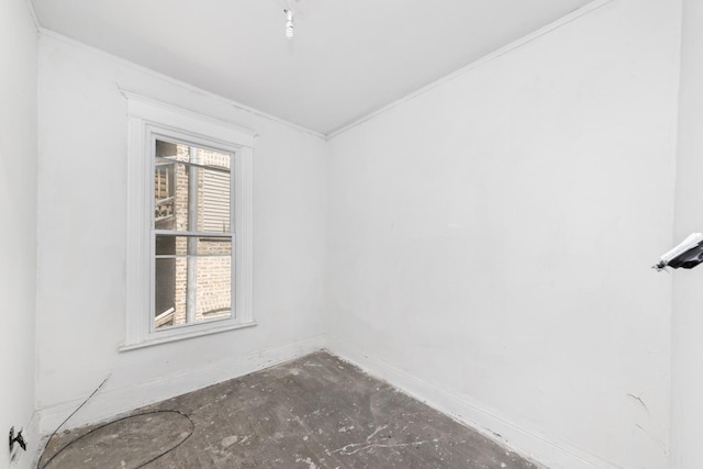 unfurnished room with a wealth of natural light and crown molding