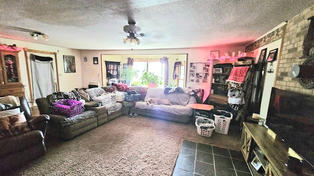 living room with a textured ceiling, dark carpet, and ceiling fan