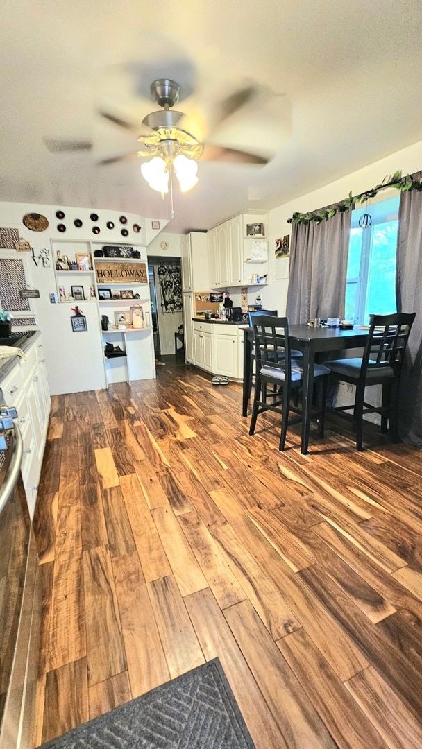 kitchen featuring ceiling fan, hardwood / wood-style flooring, and white cabinets