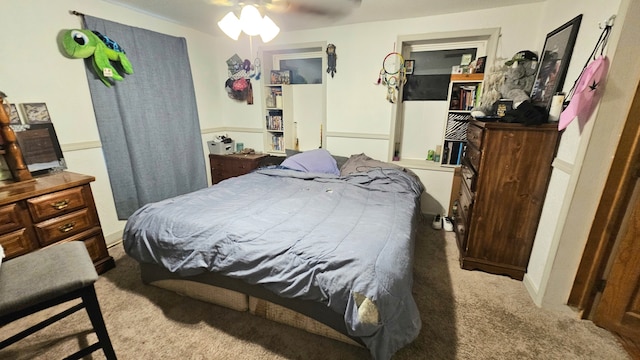 bedroom featuring ceiling fan and light carpet