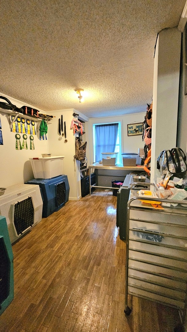 bedroom with wood-type flooring and a textured ceiling