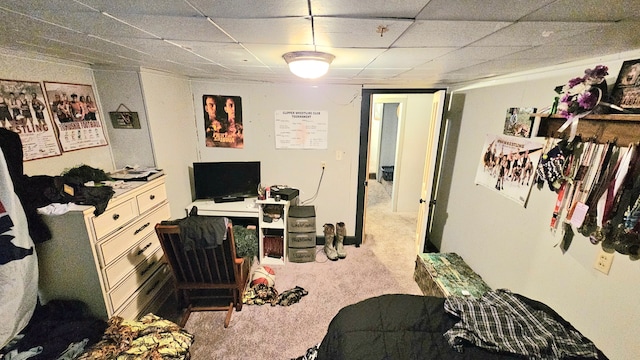 bedroom with light carpet and a drop ceiling