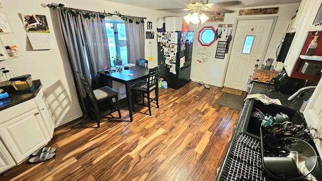 dining area featuring ceiling fan and dark hardwood / wood-style flooring