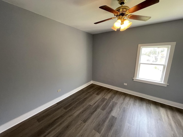 unfurnished room featuring ceiling fan, baseboards, and dark wood-style flooring