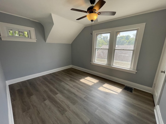bonus room with dark wood-type flooring, a healthy amount of sunlight, visible vents, and baseboards