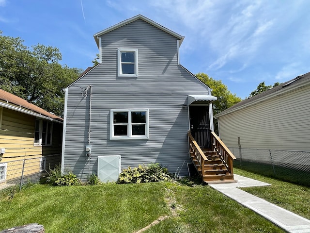 rear view of house with a lawn