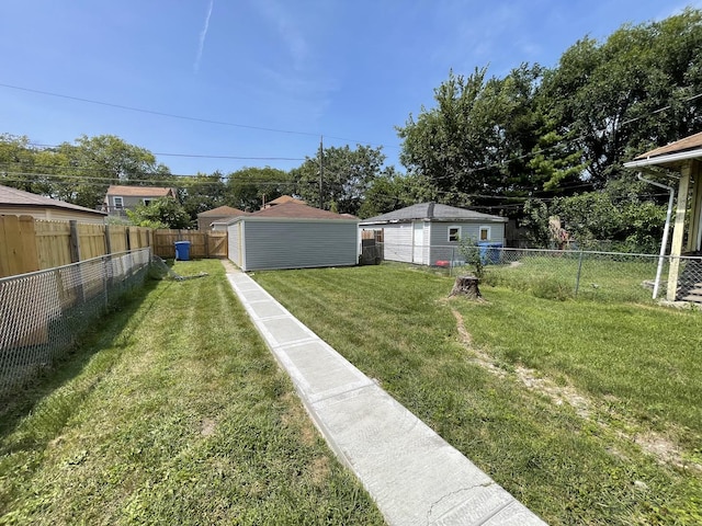 view of yard with an outdoor structure and a fenced backyard