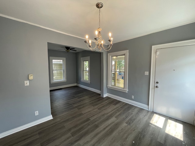 unfurnished dining area with ceiling fan with notable chandelier, dark hardwood / wood-style flooring, and ornamental molding