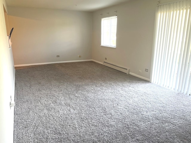 carpeted spare room featuring a baseboard radiator