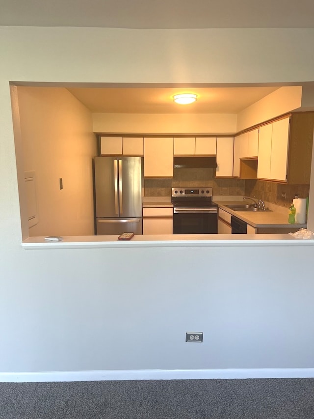 kitchen featuring stainless steel appliances, decorative backsplash, and sink