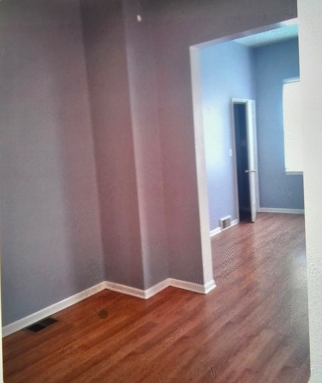 unfurnished room featuring wood-type flooring