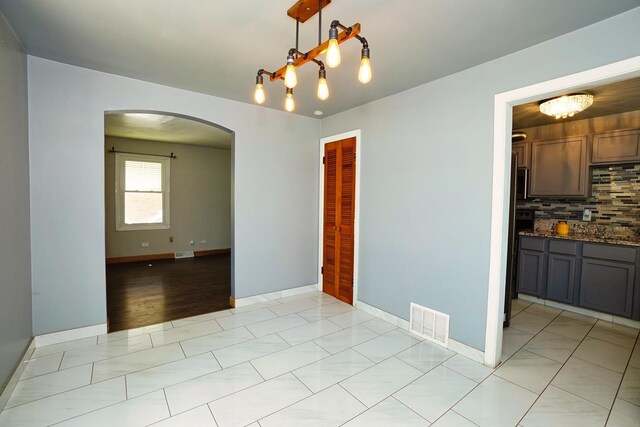 unfurnished dining area featuring light hardwood / wood-style floors