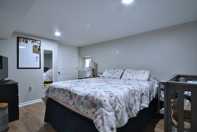 bedroom with hardwood / wood-style flooring