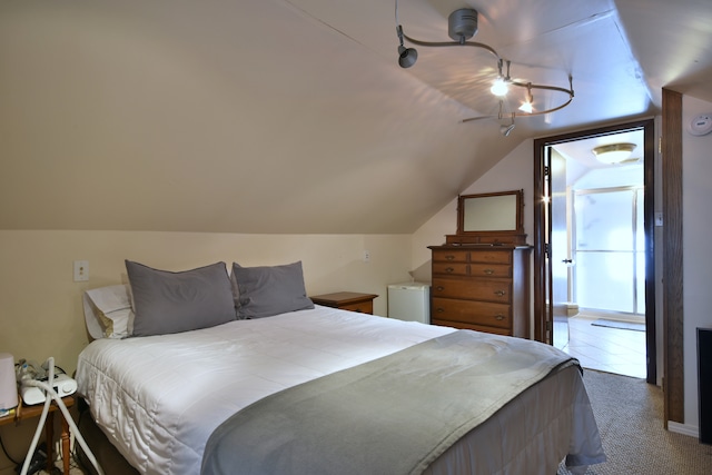 carpeted bedroom featuring vaulted ceiling and ceiling fan