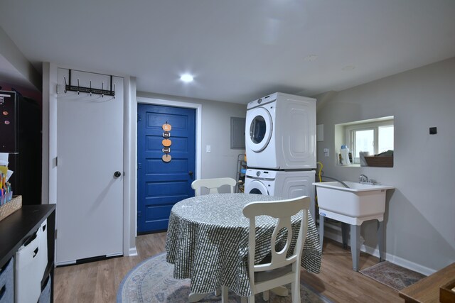 dining area featuring hardwood / wood-style flooring and stacked washer and clothes dryer