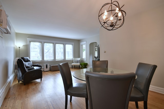 dining area with an inviting chandelier and wood-type flooring