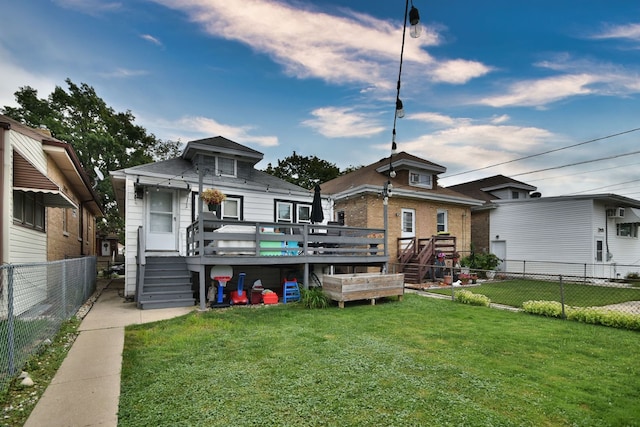 rear view of house featuring a lawn