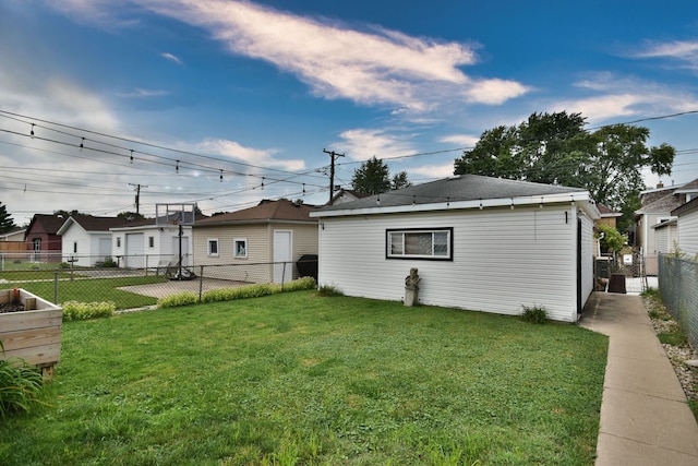 back of house with a lawn