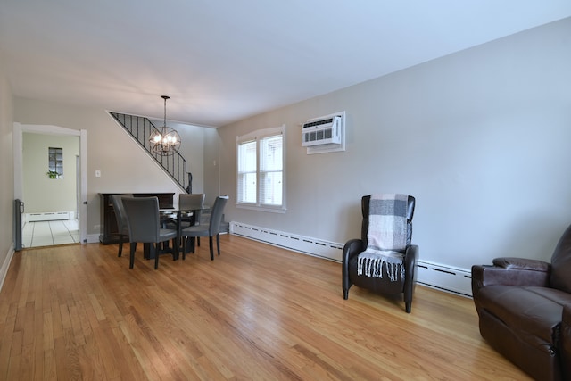 dining area with light wood-type flooring, a wall mounted AC, baseboard heating, and an inviting chandelier