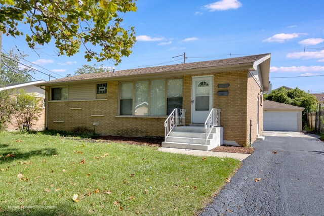 single story home featuring a garage and a front lawn