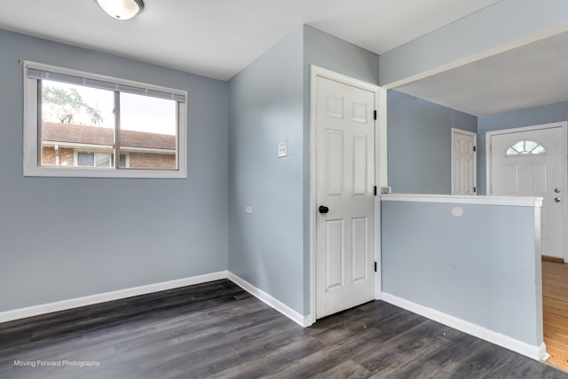 empty room with dark hardwood / wood-style flooring