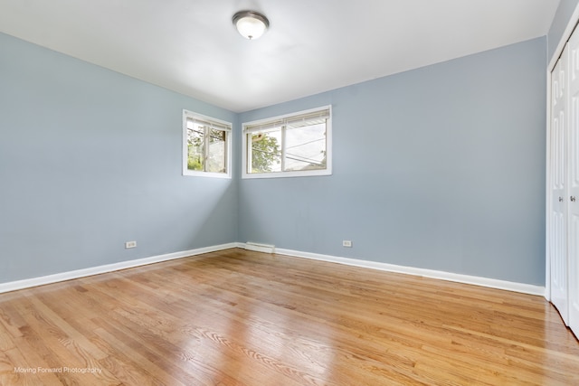 unfurnished room with wood-type flooring