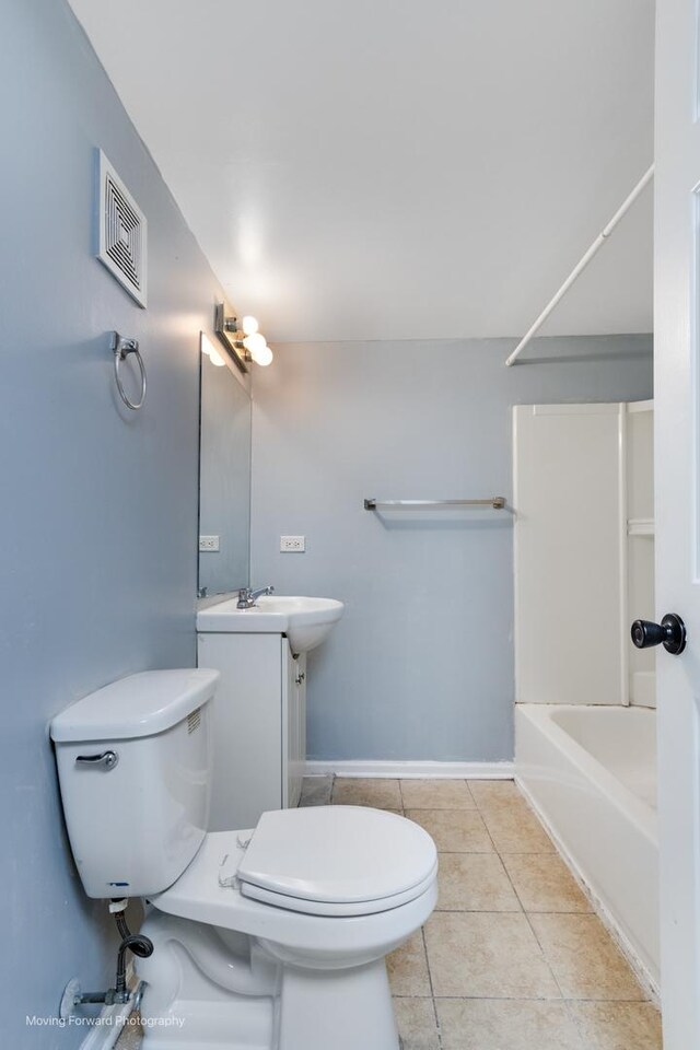 full bathroom with vanity, toilet,  shower combination, and tile patterned floors