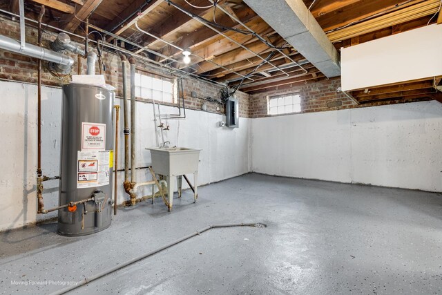 basement featuring electric panel and gas water heater