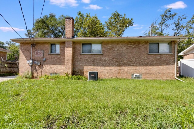 rear view of property with a yard