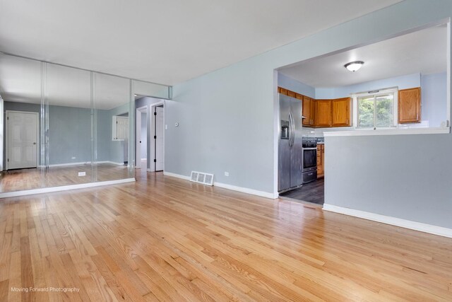 unfurnished living room with light hardwood / wood-style floors